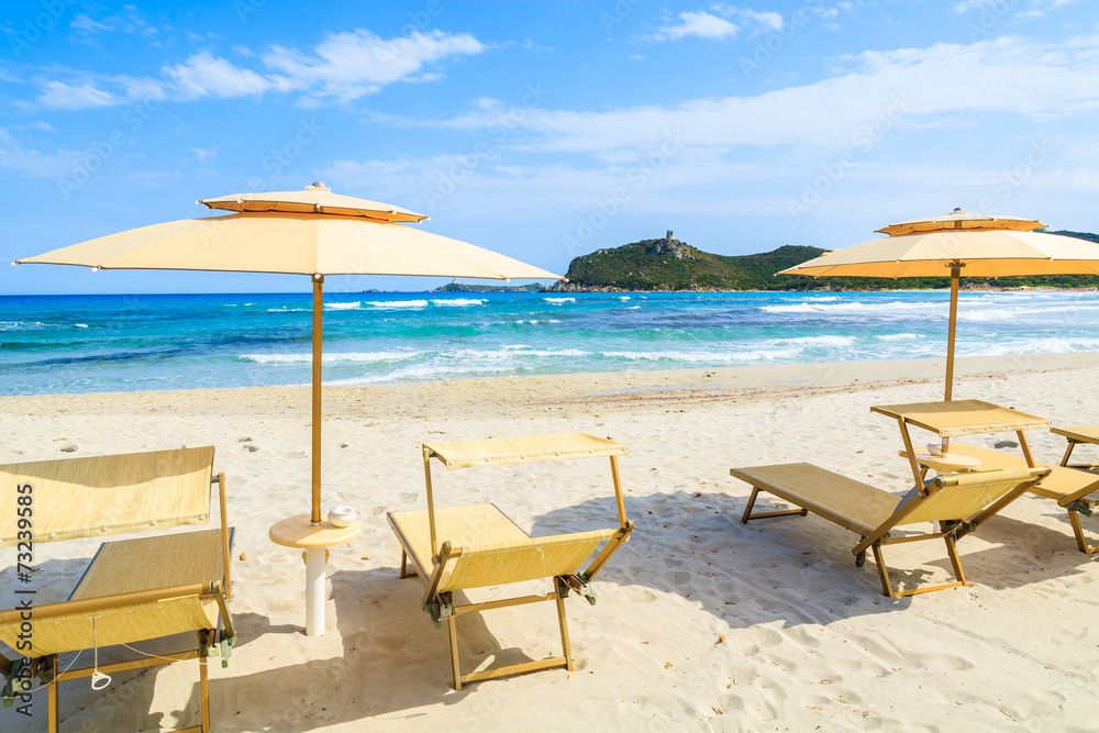 Sunbeds with umbrellas on Porto Giunco beach, Sardinia island