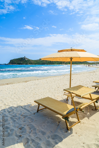 Villasimius beach with sunchairs and umbrellas  Sardinia island
