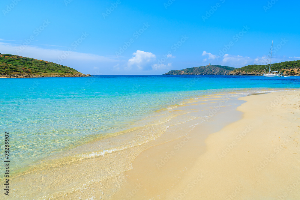 Sand and turquoise sea water of Teuleda beach, Sardinia island