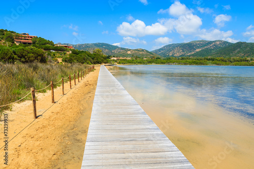 Wooden walkway to Chia beach along a salt lake  Sardinia island