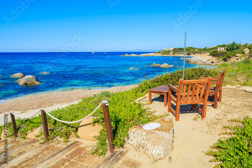 Wooden chairs and table on Cala Caterina beach, Sardinia island © pkazmierczak