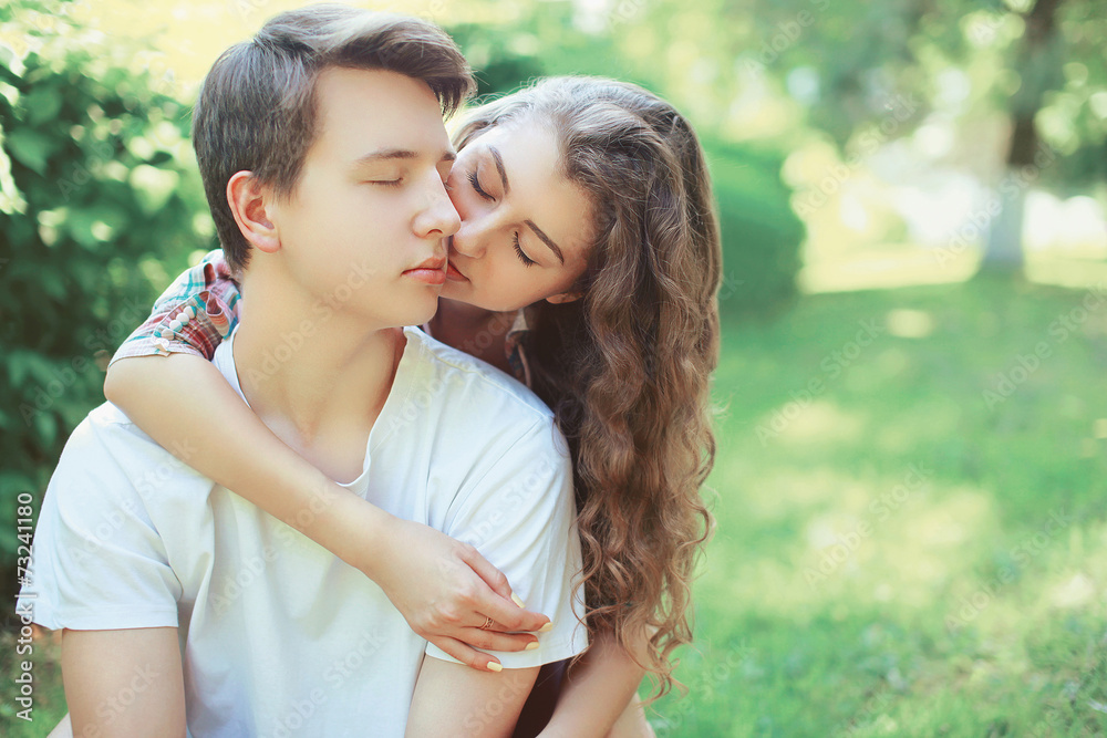 Lovely young couple teenagers in love, kiss outdoors Lovely young couple teenagers in love, kiss outdoors