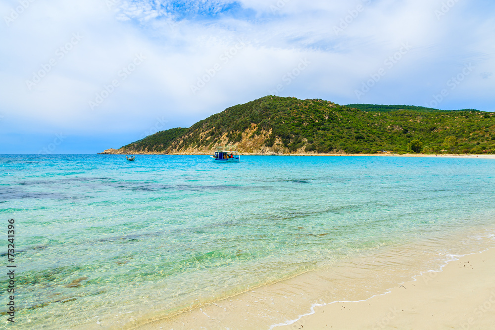 Fototapeta premium Fishing boat on turquoise sea water, Cala Pira, Sardinia island