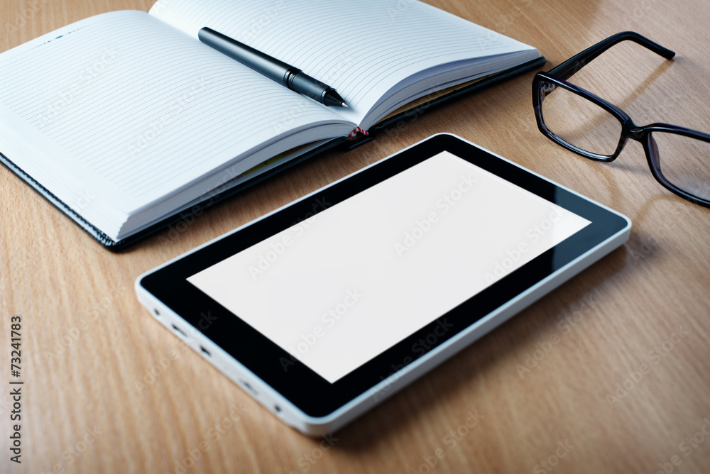 Modern tablet PC next to a classical open agenda Modern tablet PC next to a classical open agenda