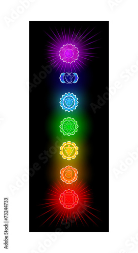 Glowing seven chakras on black background