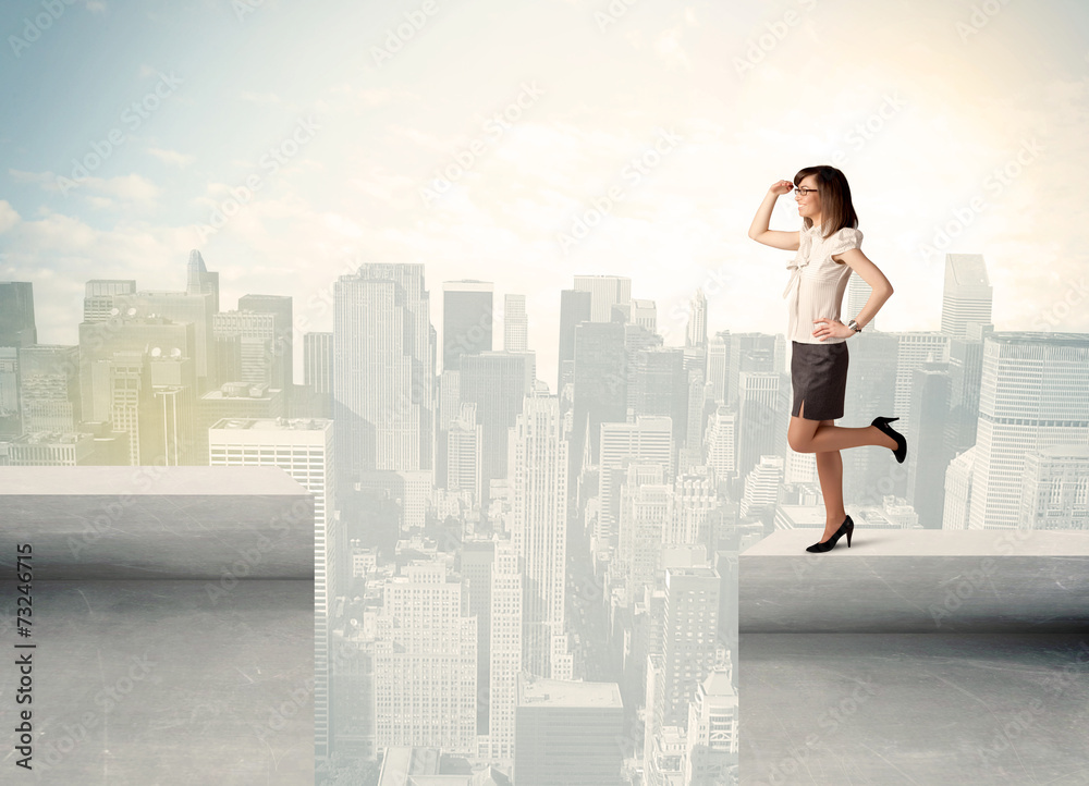 Businesswoman standing on the edge of rooftop Businesswoman standing on the edge of rooftop