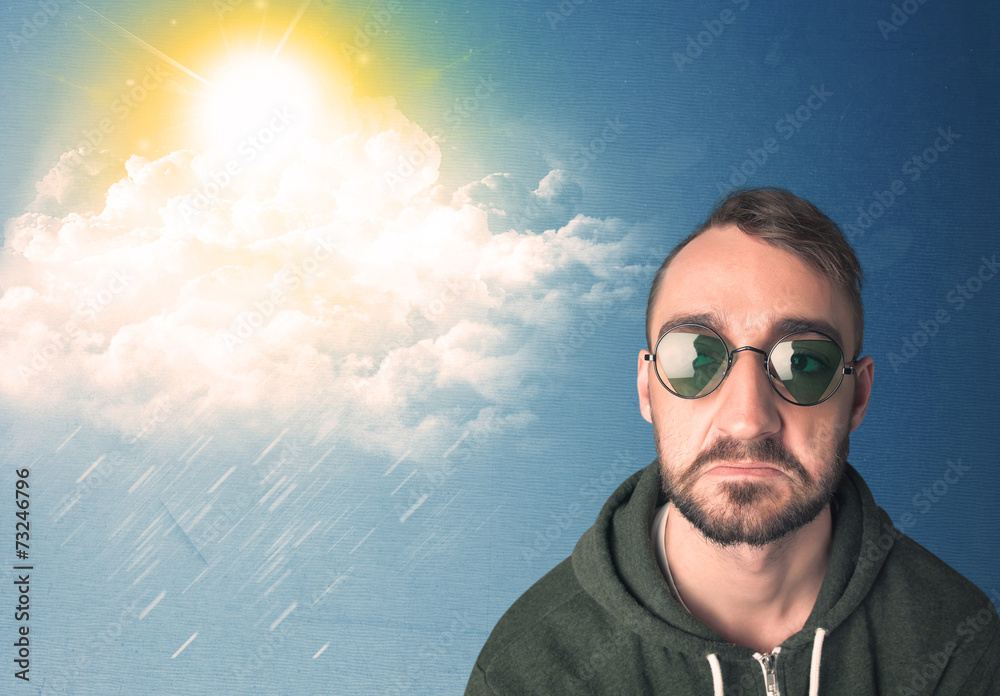 Young person looking with sunglasses at clouds and sun Young person looking with sunglasses at clouds and sun