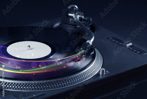Turntable playing vinyl with glowing abstract lines