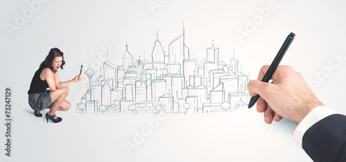 Businesswoman looking at hand drawn city on wall