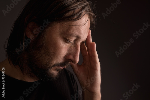 Bearded adult man with migraine headache © Bits and Splits