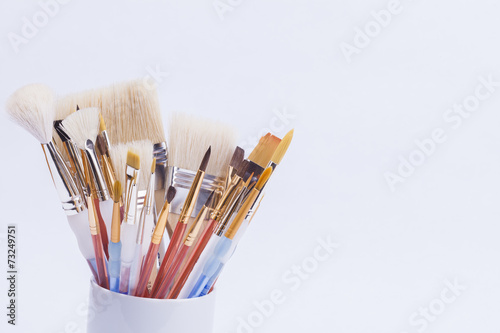 artists paint brushes in cup