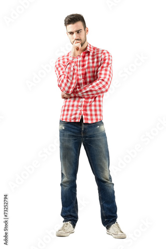 Worried standing man looking down isolated