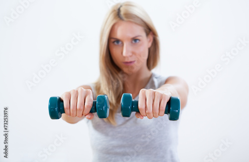 Beauty woman training with dumbbells