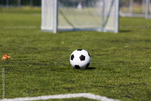 Green pitch with soccer ball