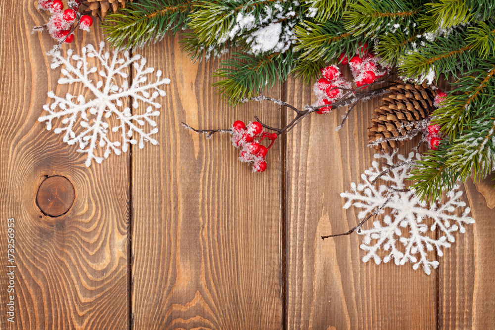 Christmas wooden background with snow fir tree and decor Christmas wooden background with snow fir tree and decor