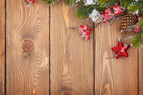 Christmas wooden background with snow fir tree and decor