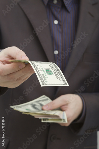 Man holding a hundred dollar bill