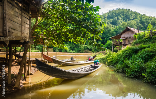 Long-tail boats moored in a village of stilt houses