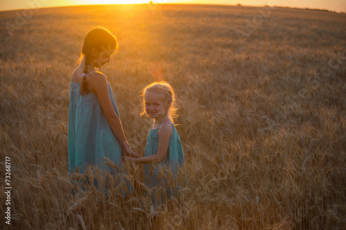 two child girls at the sunset field