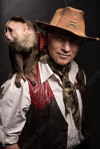 Photography Mature man adventurer with his monkey companion