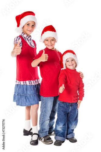 Three kids in Christmas hats