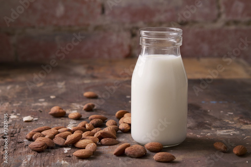 Almond milk in a glass jar with almonds