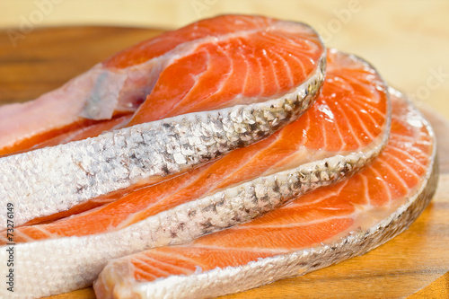 Delicious portion of fresh salmon fillet on a wooden table