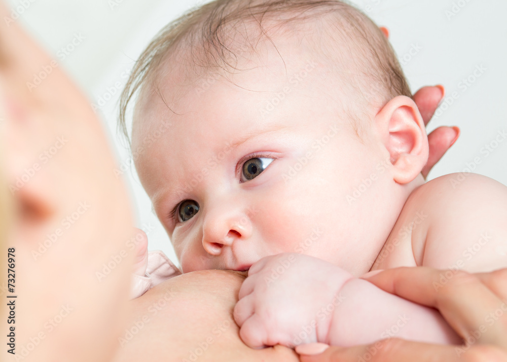 Baby feeds on mother's breasts milk Baby feeds on mother's breasts milk
