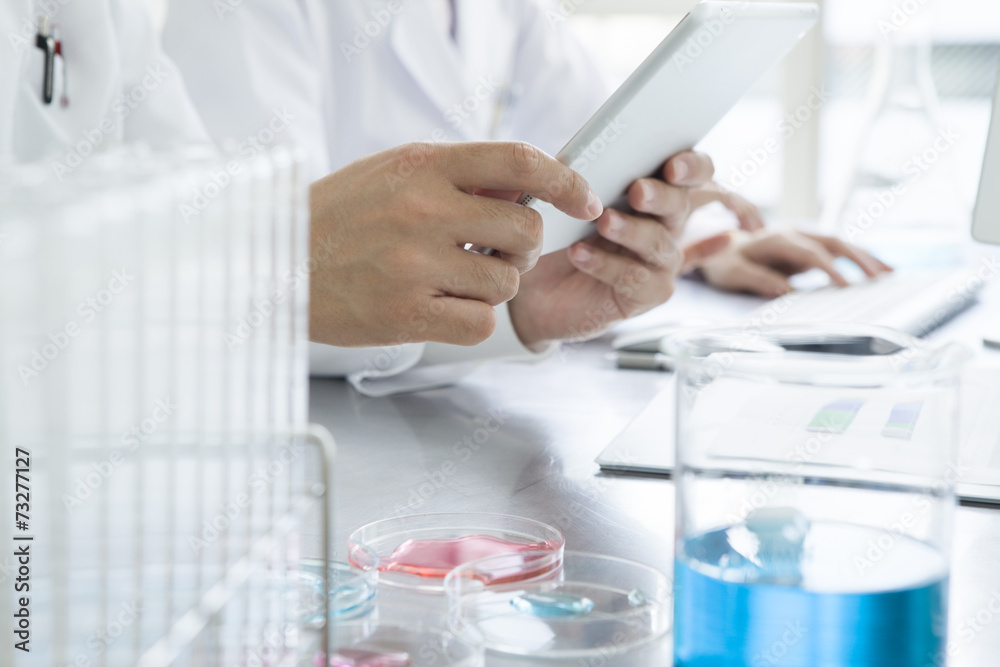 Men are using tablet in the laboratory Men are using tablet in the laboratory