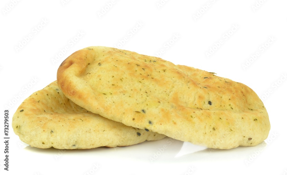 Two pieces of garlic coriander naan bread on a white background Two pieces of garlic coriander naan bread on a white background