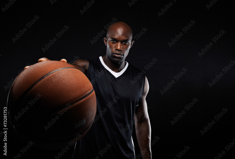 Professional basketball player against black background Professional basketball player against black background