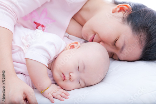 Newborn baby girl sleeping in mother arm
