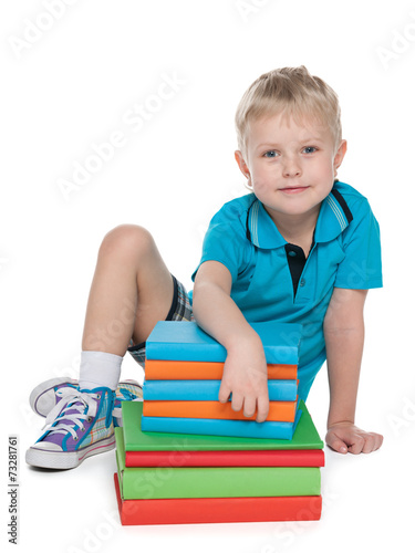 Bild auf Leinwand Young blond boy with books