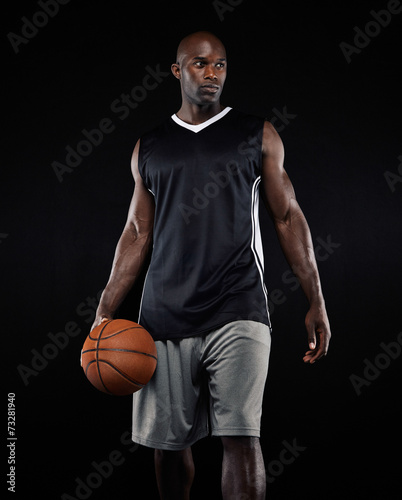 Portrait of basketball player on black background