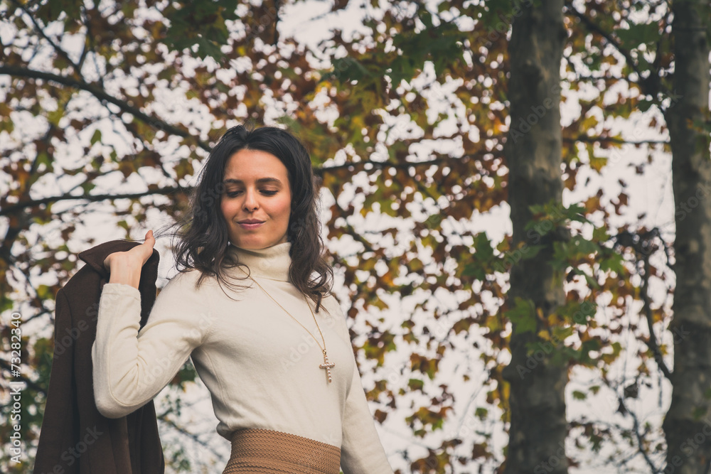 Beautiful young woman posing in a city park Beautiful young woman posing in a city park