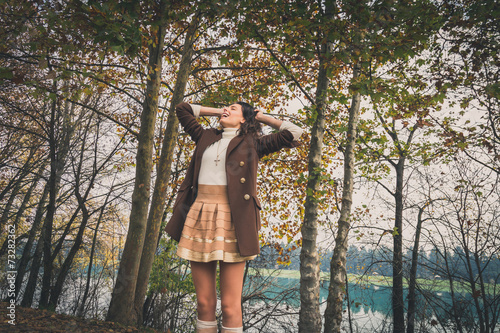 Beautiful young woman posing in a city park