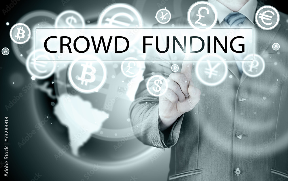 Businessman pushes virtual crowd funding button Businessman pushes virtual crowd funding button
