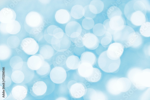 Holiday blue background with blurred bokeh lights