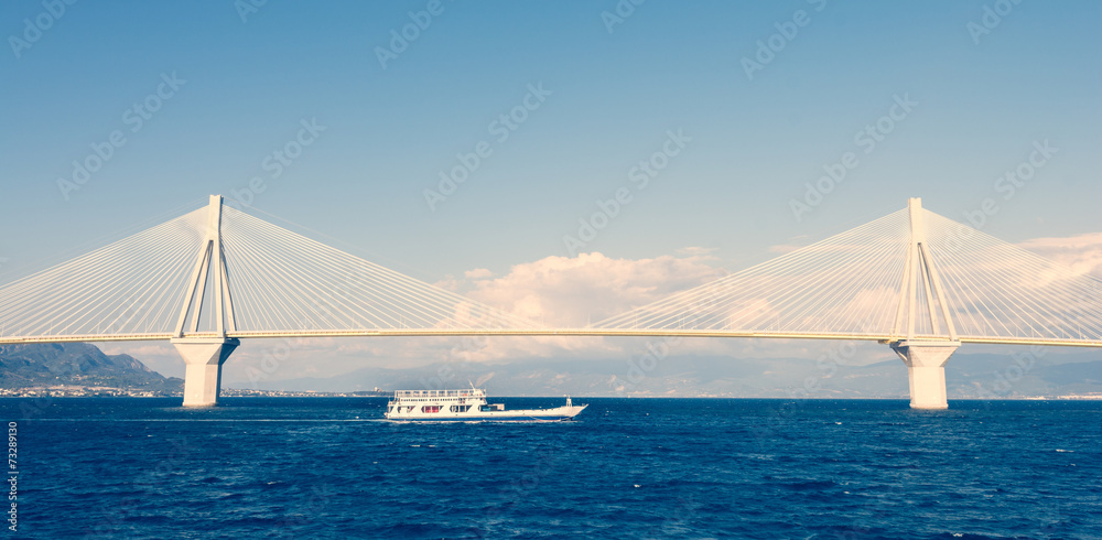 Ferry boat sailing under suspension bridge - obrazy, fototapety, plakaty 