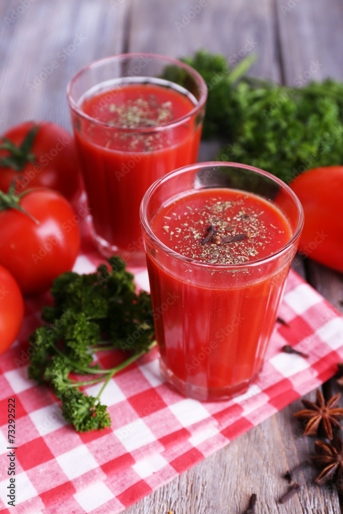 Tomato juice in glasses and fresh vegetables Tomato juice in glasses and fresh vegetables