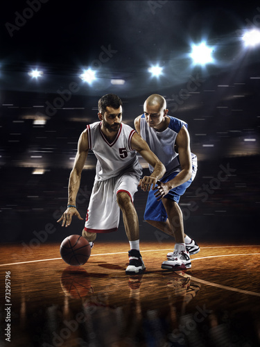 Two basketball players in action © 103tnn