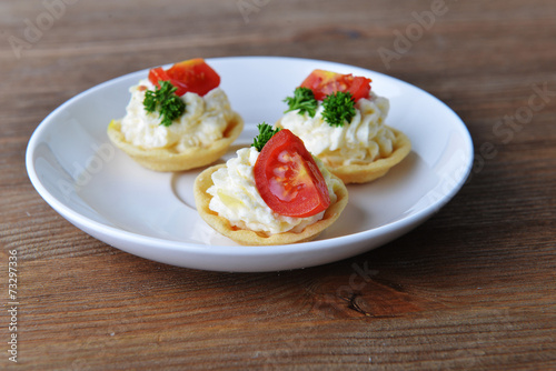 tartlet with cream, tomato and dill