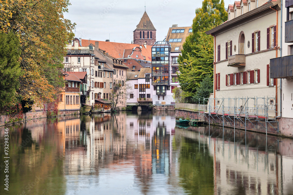 Colorful houses reflecting in water of river Ill in Strasbourg