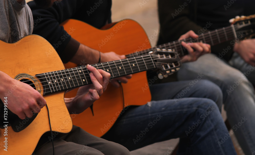 two guitarists play music on the street unplugged