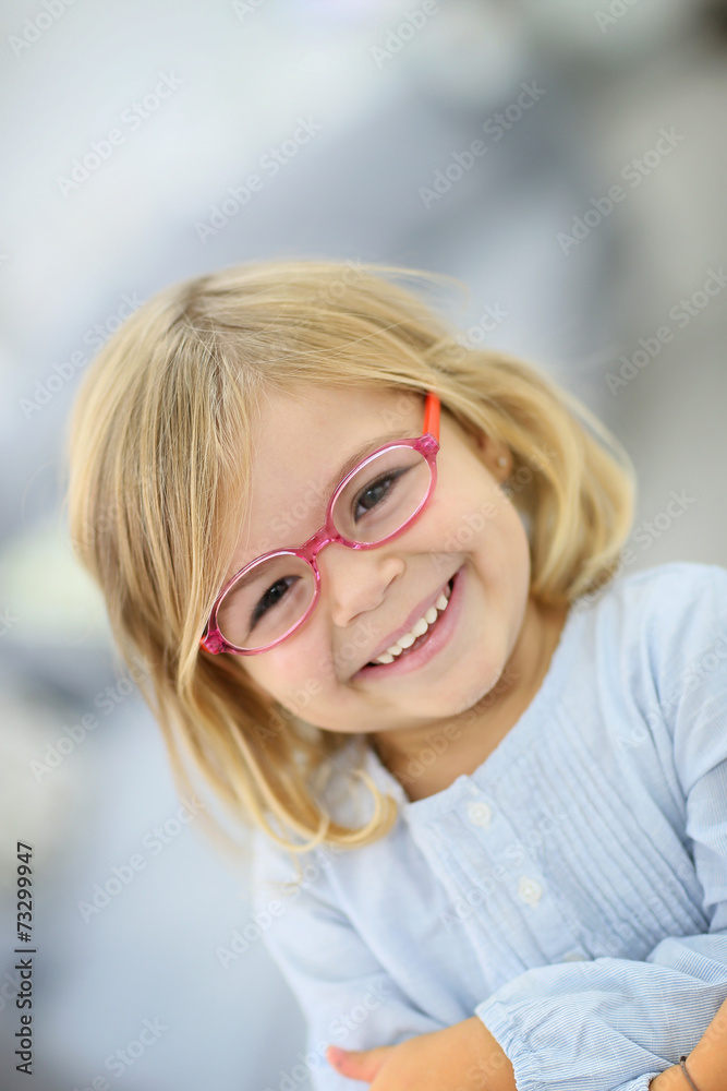 Cute blond little girl with pink eyeglasses Cute blond little girl with pink eyeglasses