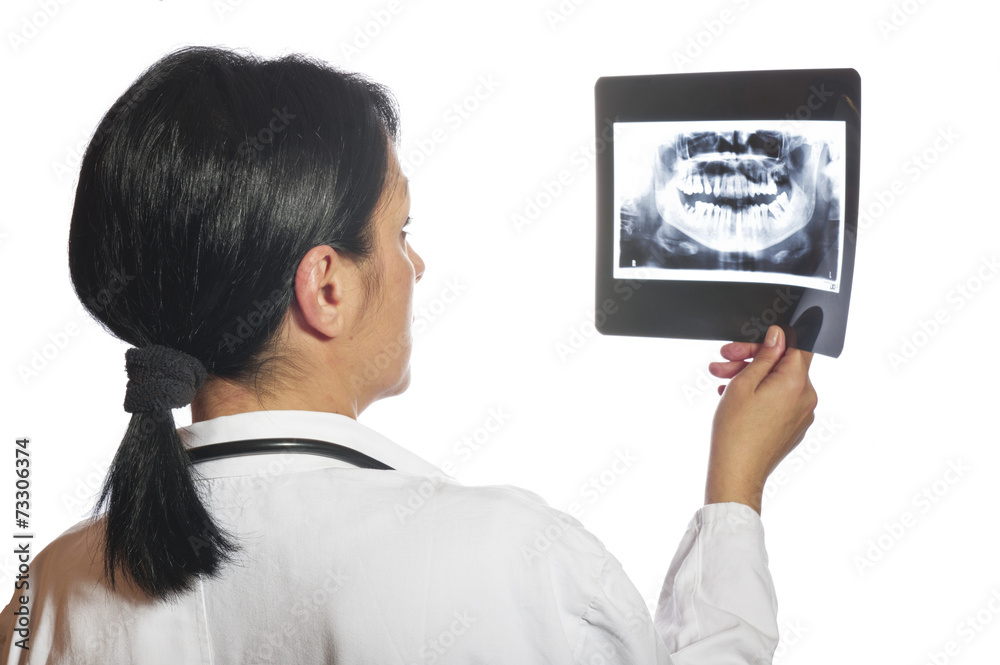 Dentist checking x-ray at dental clinic Dentist checking x-ray at dental clinic