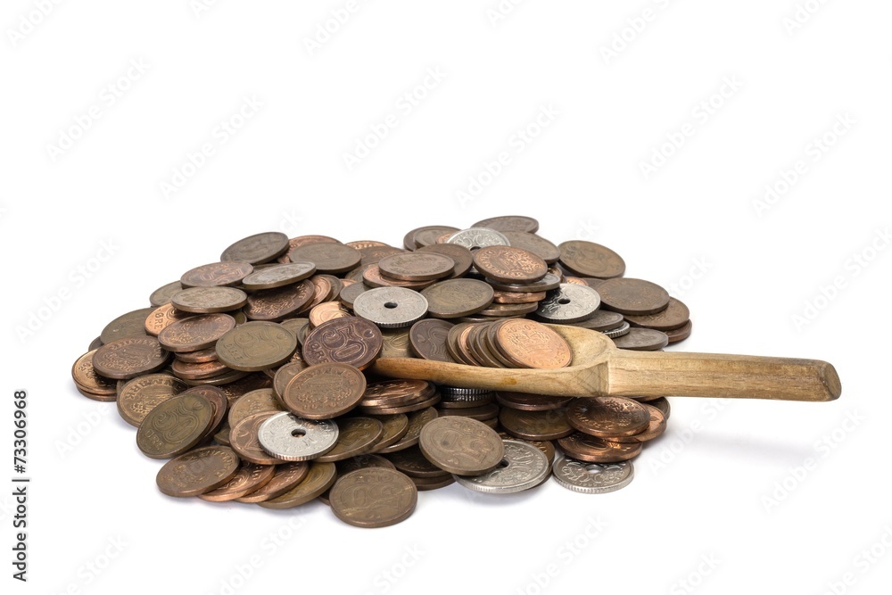 pile of danish coins on white background with a wooden spoon pile of danish coins on white background with a wooden spoon