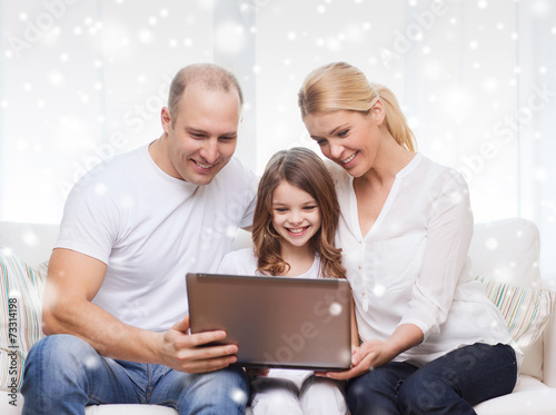 smiling family with laptop at home