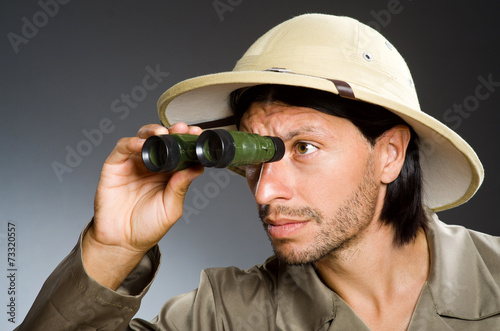 Funny safari hunter against background