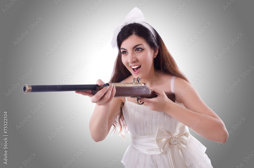 Fototapeta premium Bride with rifle isolated on white